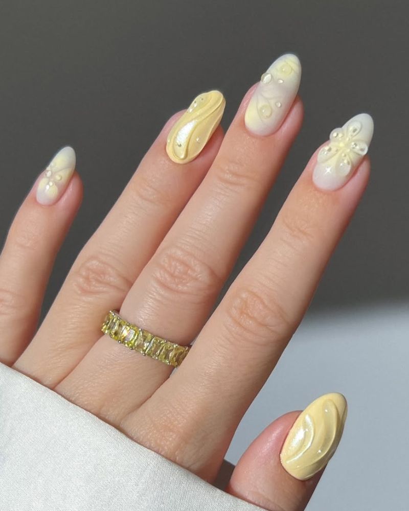 pastel yellow nails with 3d floral nail art for spring manicure