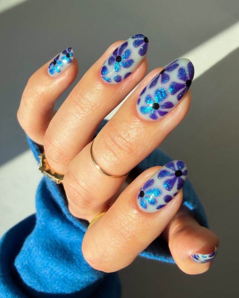 milky white base with blue flowers nail art design