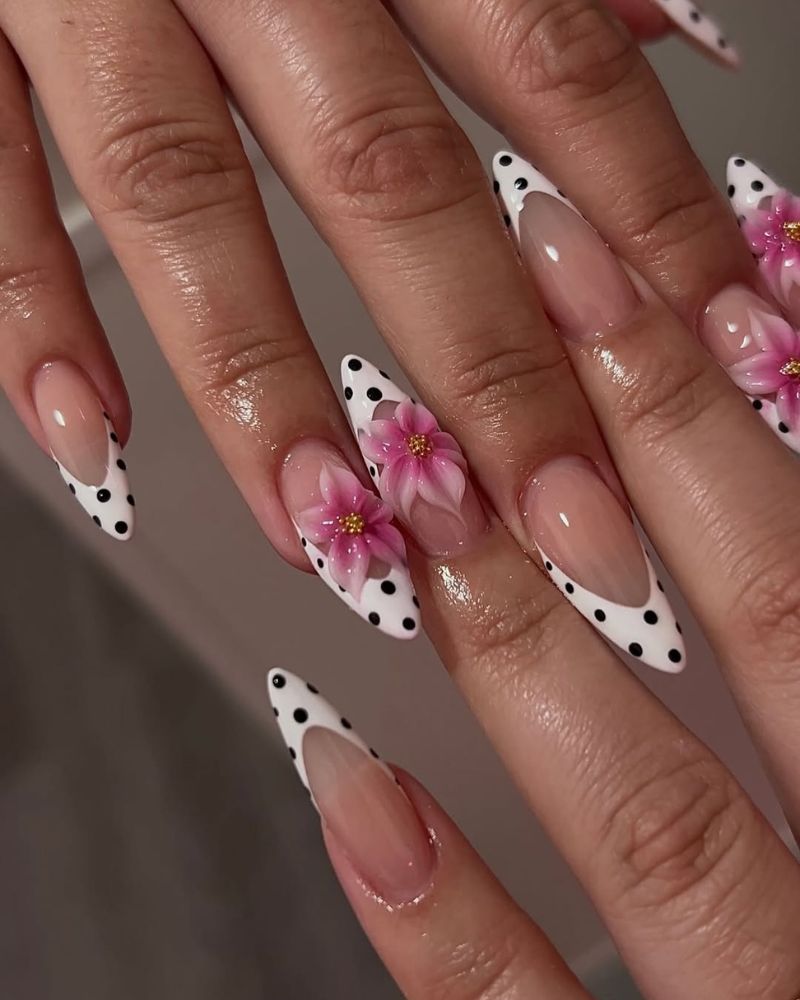 simple white french tip nails with black polka dots and pink 3d flowers