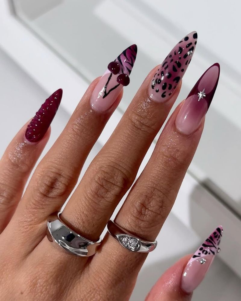 long stiletto nails with burgundy and cherry nail art