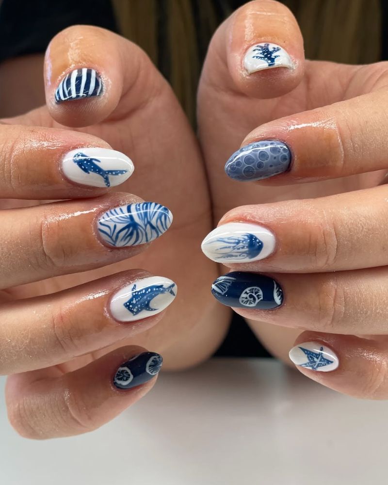 navy blue and white nails with oceanic nail art
