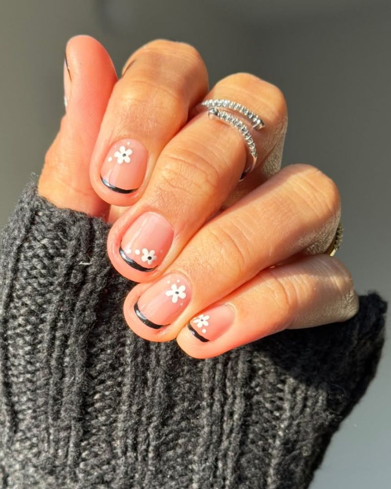 short nails with black french tips with little flowers