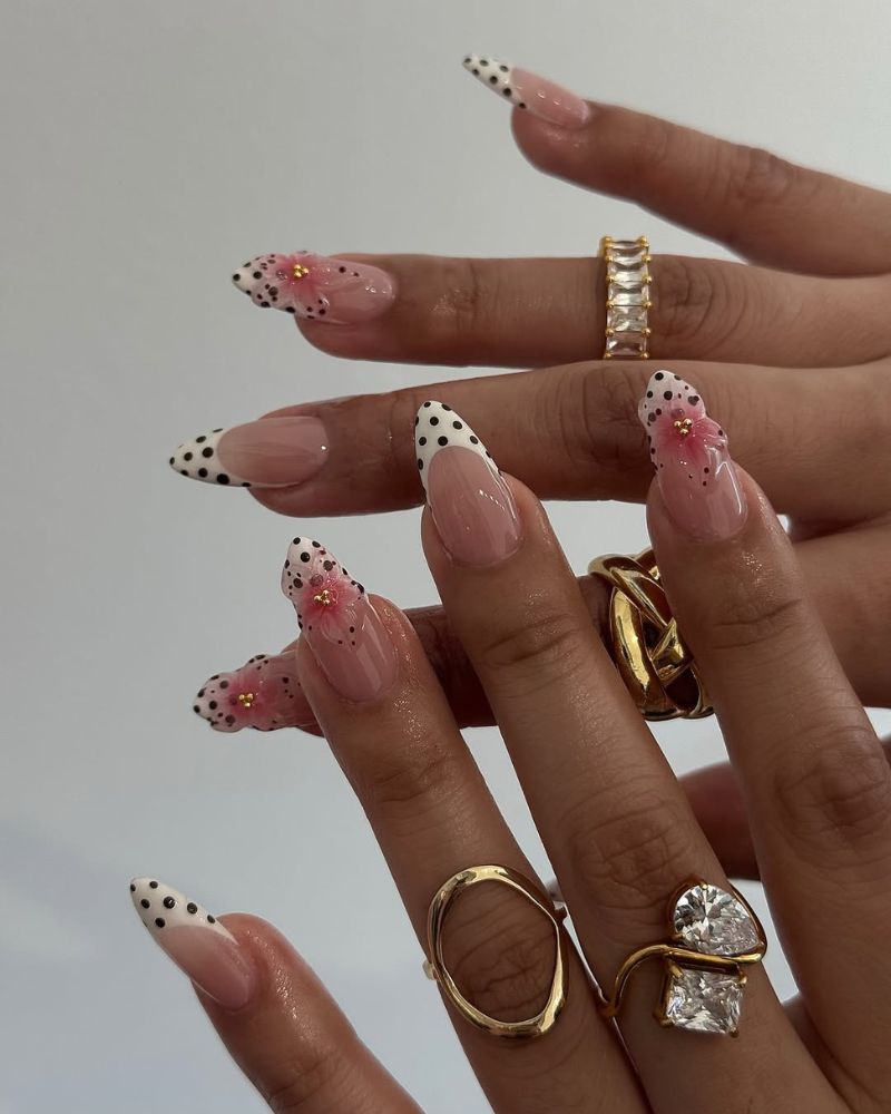 white tip french nail design with black polka dots with 3d flowers