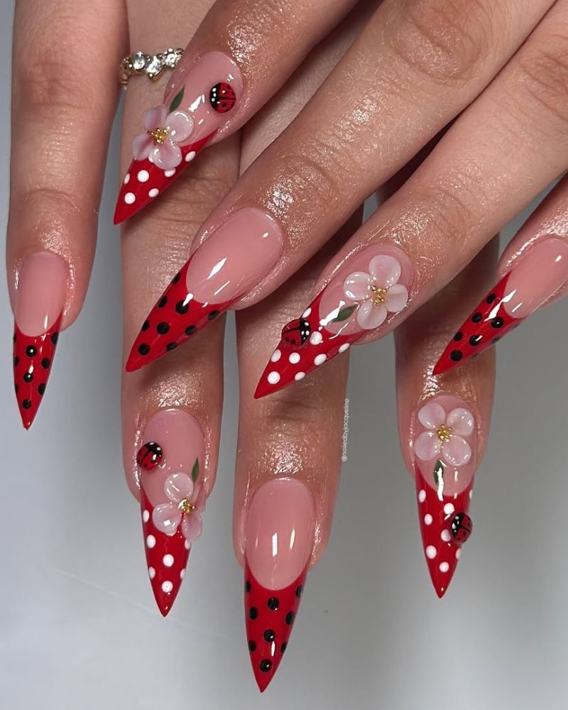 ladybug nail art design on long and sharp stiletto shape