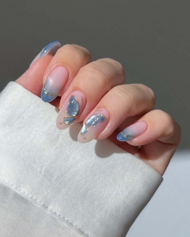 butterfly nail design on a clean nude base for spring manicure