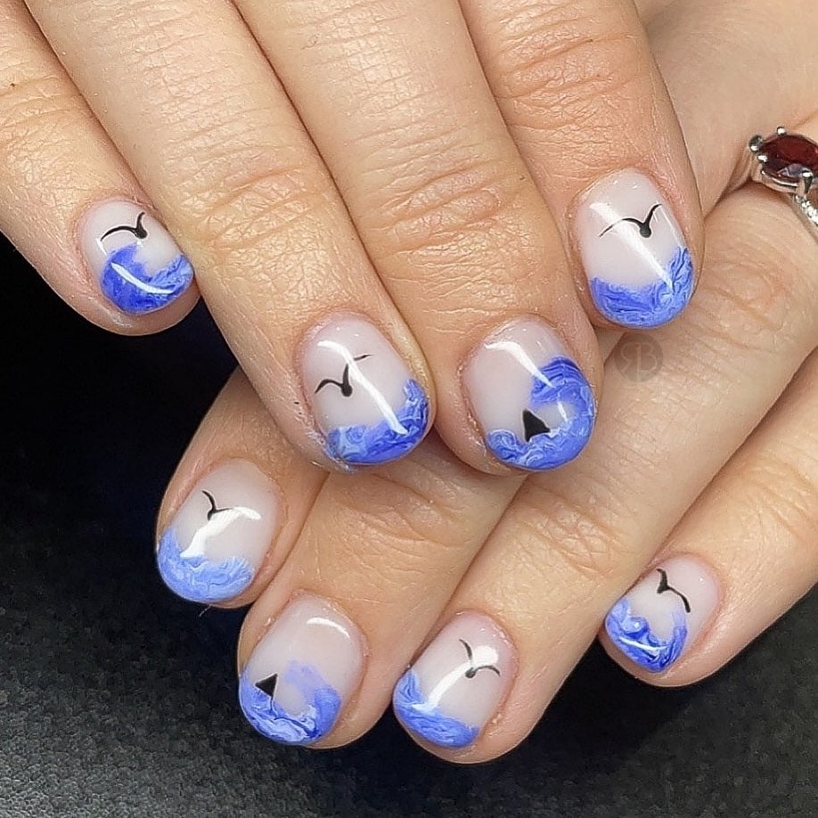 Seaside inspired nails with blue skies and sunshine