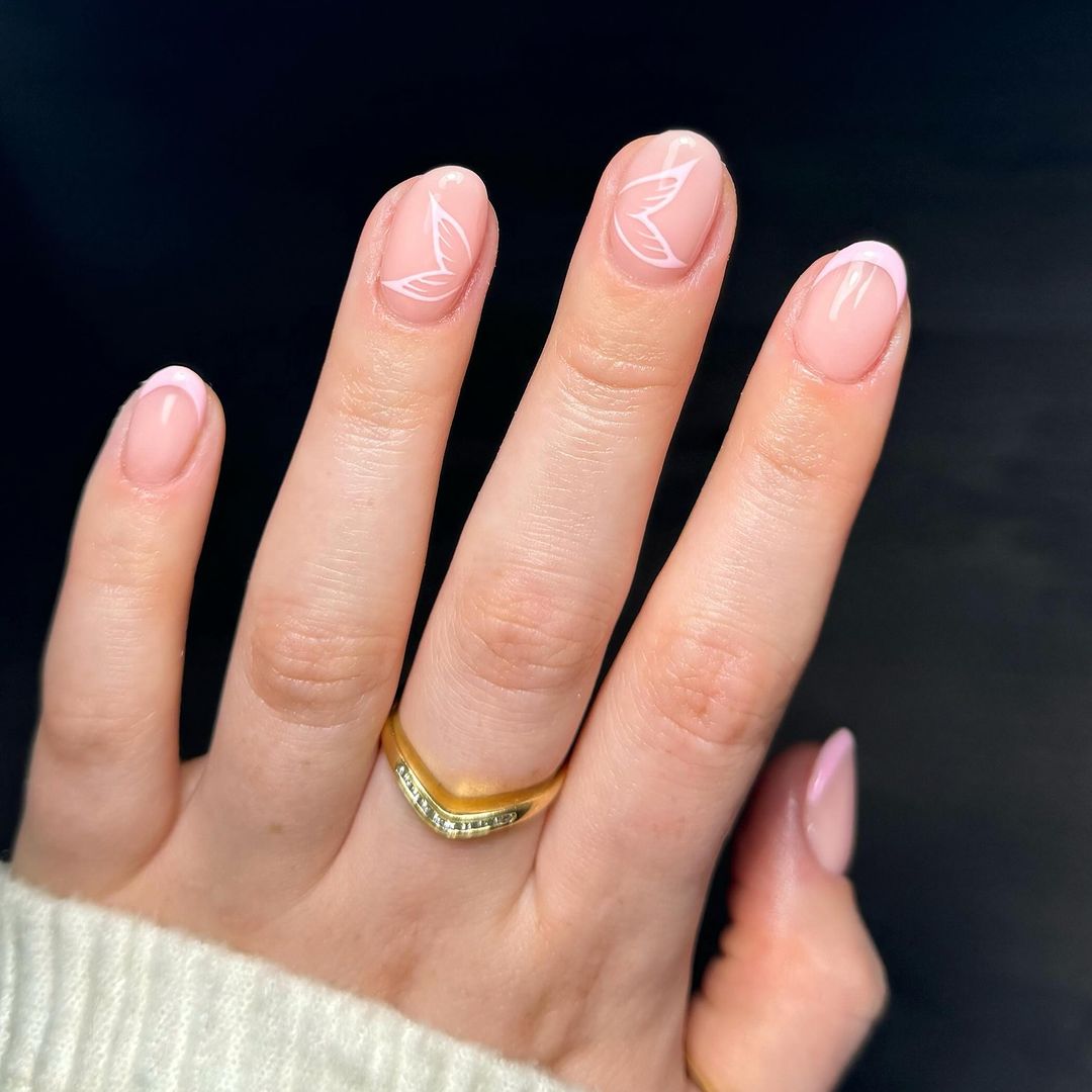 Subtle butterfly nail art on pastel pink
