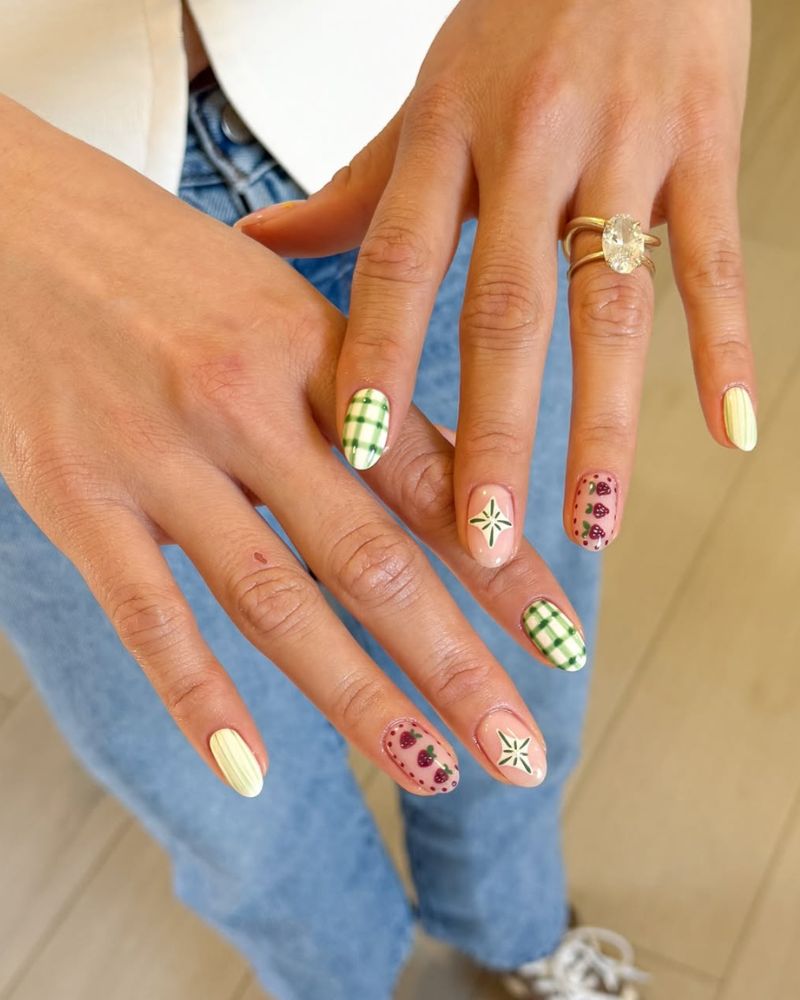 cute spring nail art design with gingham pattern, strawberries and glass strips