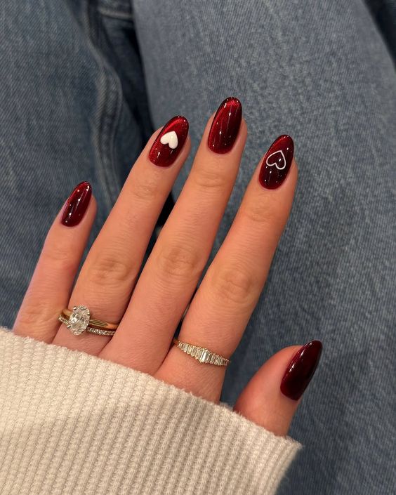 8. Romantic Elegance: Deep Red Nails with Heart Accents