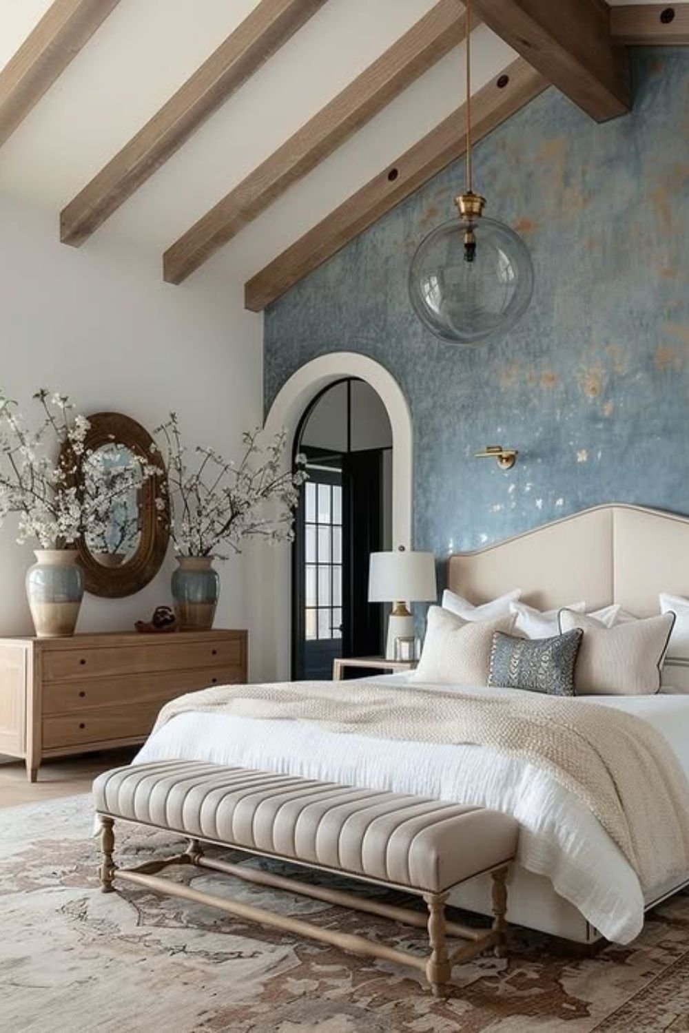Cloudy blue textured plaster wall behind a bed with wood beams