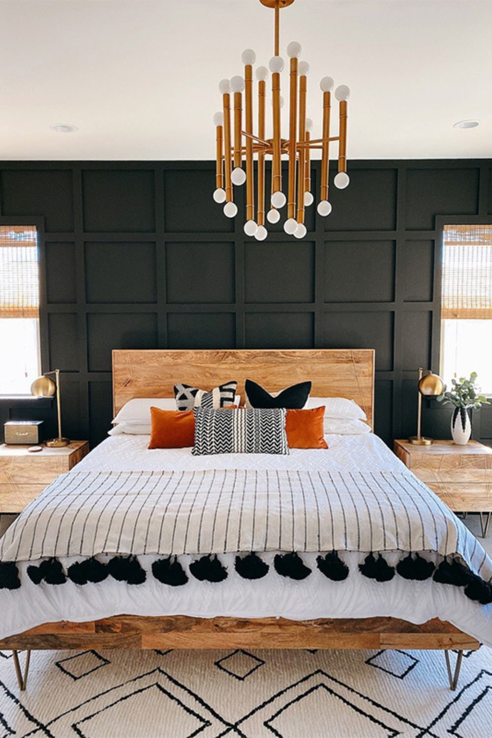 Bold grid panel wall in dark shade behind a wood headboard