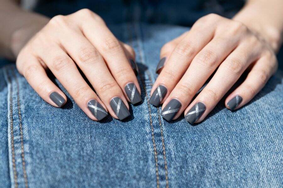 Charcoal grey square nails accented with sleek silver diagonal stripes for a modern finish.