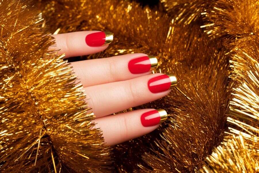 Classic red square nails with shiny gold foil tips for a bold, festive look.
