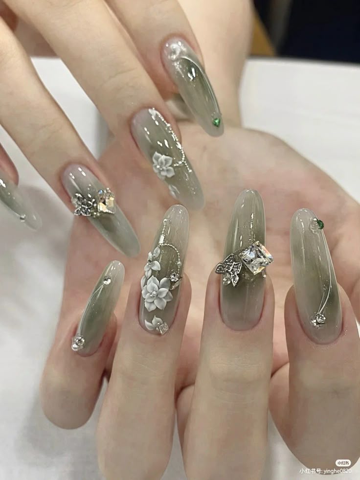 Enchanting Elegance: Sage Green Nails Adorned with Blossoms and Gems