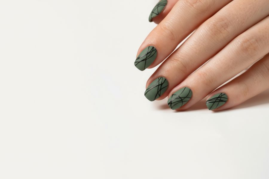 Olive green square nails featuring sleek black abstract line designs for a modern edge.