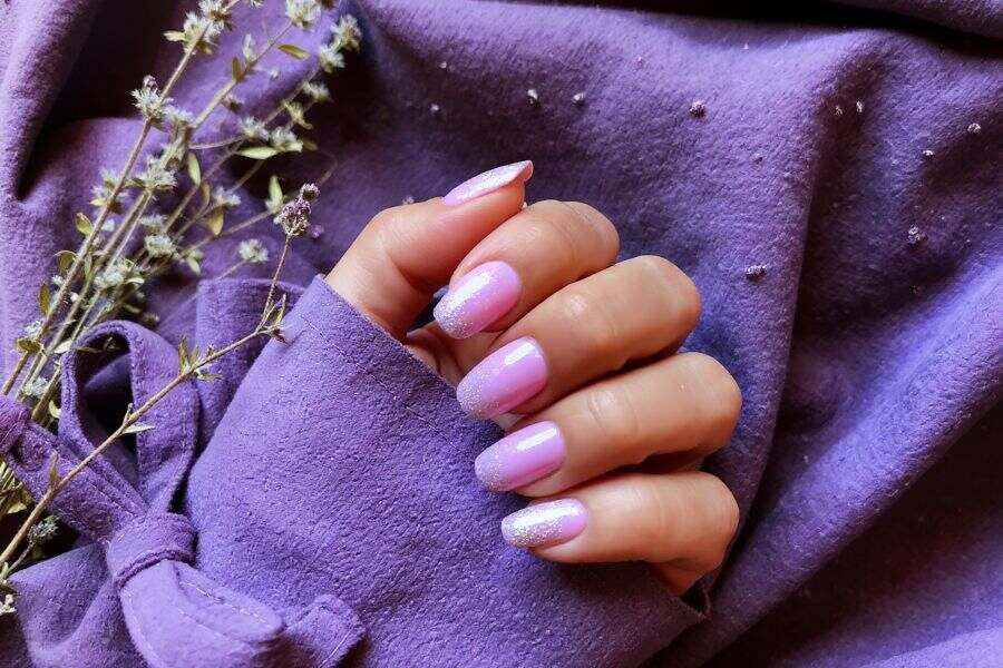Soft lilac square nails with shimmering silver glitter tips for a dreamy, elegant look.