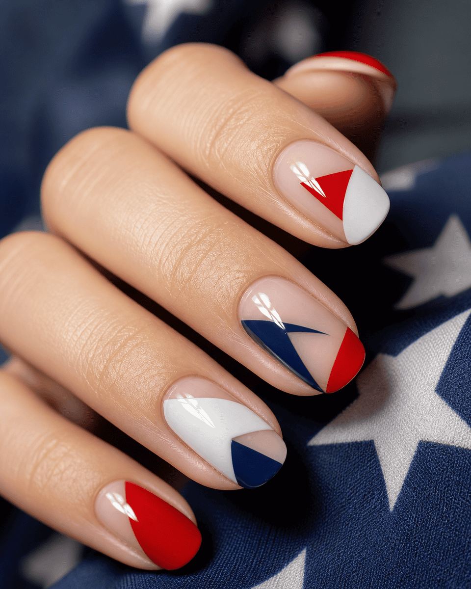 Modern negative space nail design with geometric red white and blue sections