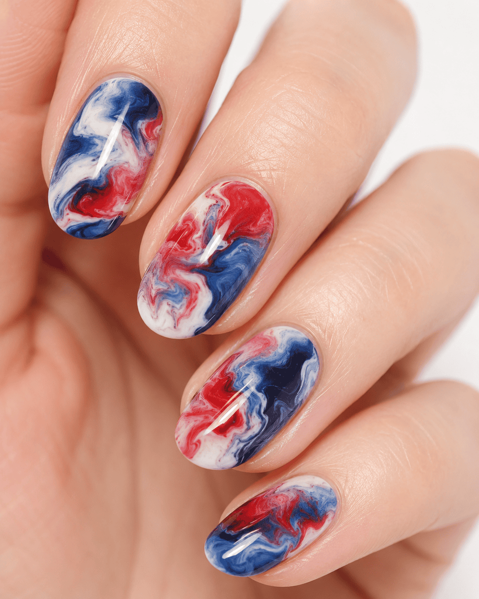Marble swirl nail art in red white and navy blue watercolor pattern