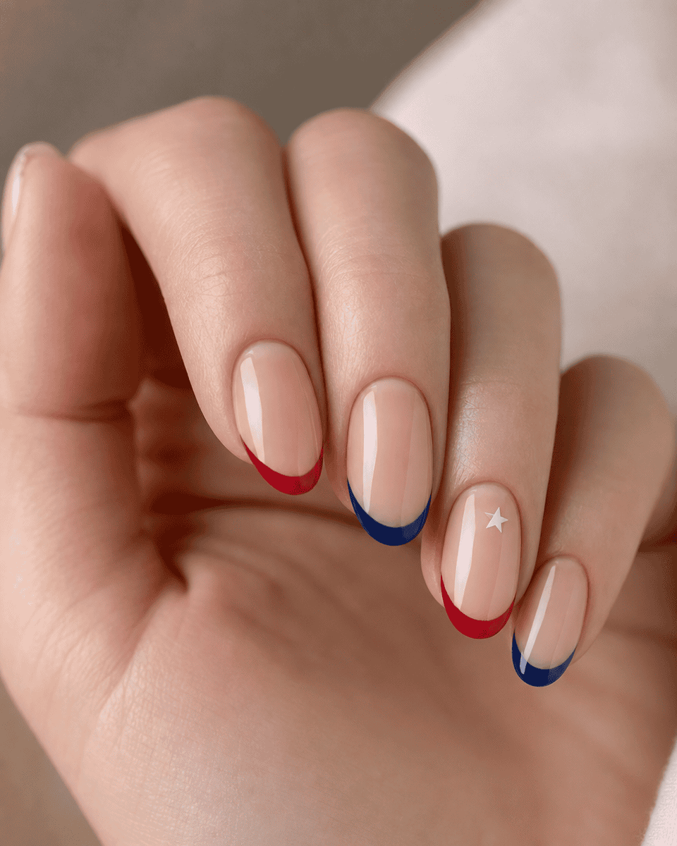 Patriotic French tip nails with alternating red and blue stripes and white star accent
