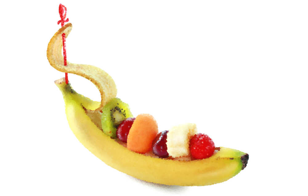 Banana scooped out and filled with fruit to make a ship.