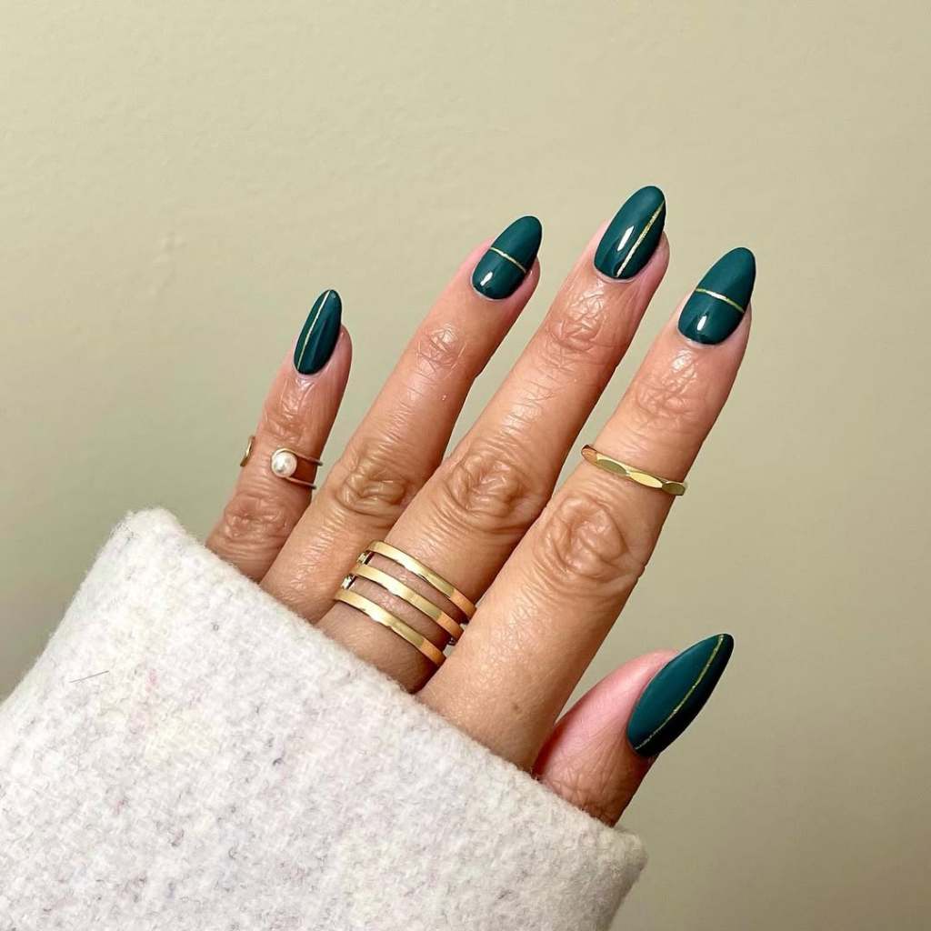 classy emerald green nails with metallic gold lines