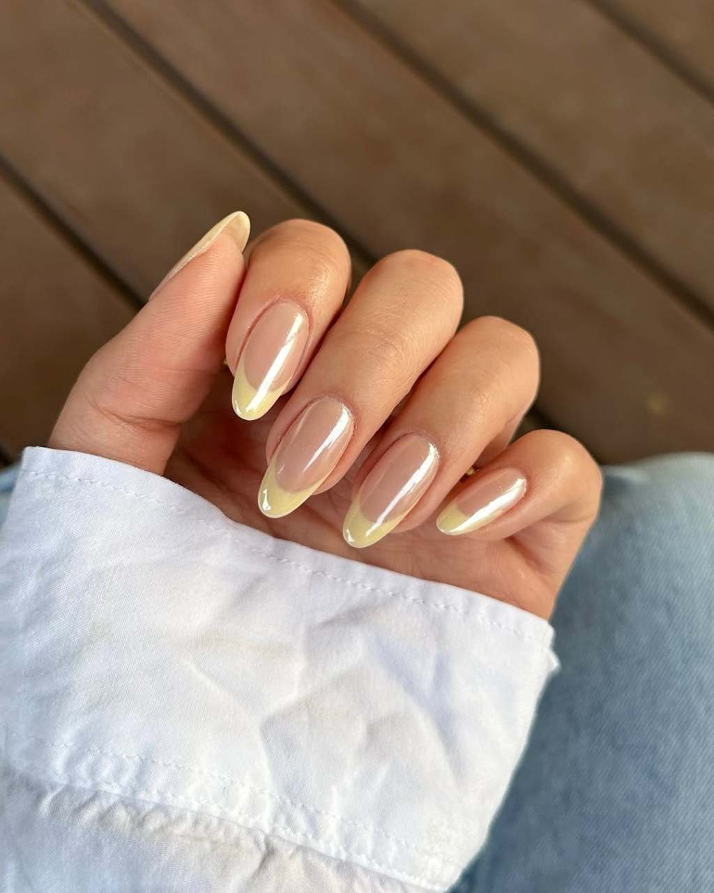 butter yellow french tip nails with a cute shimmery finish