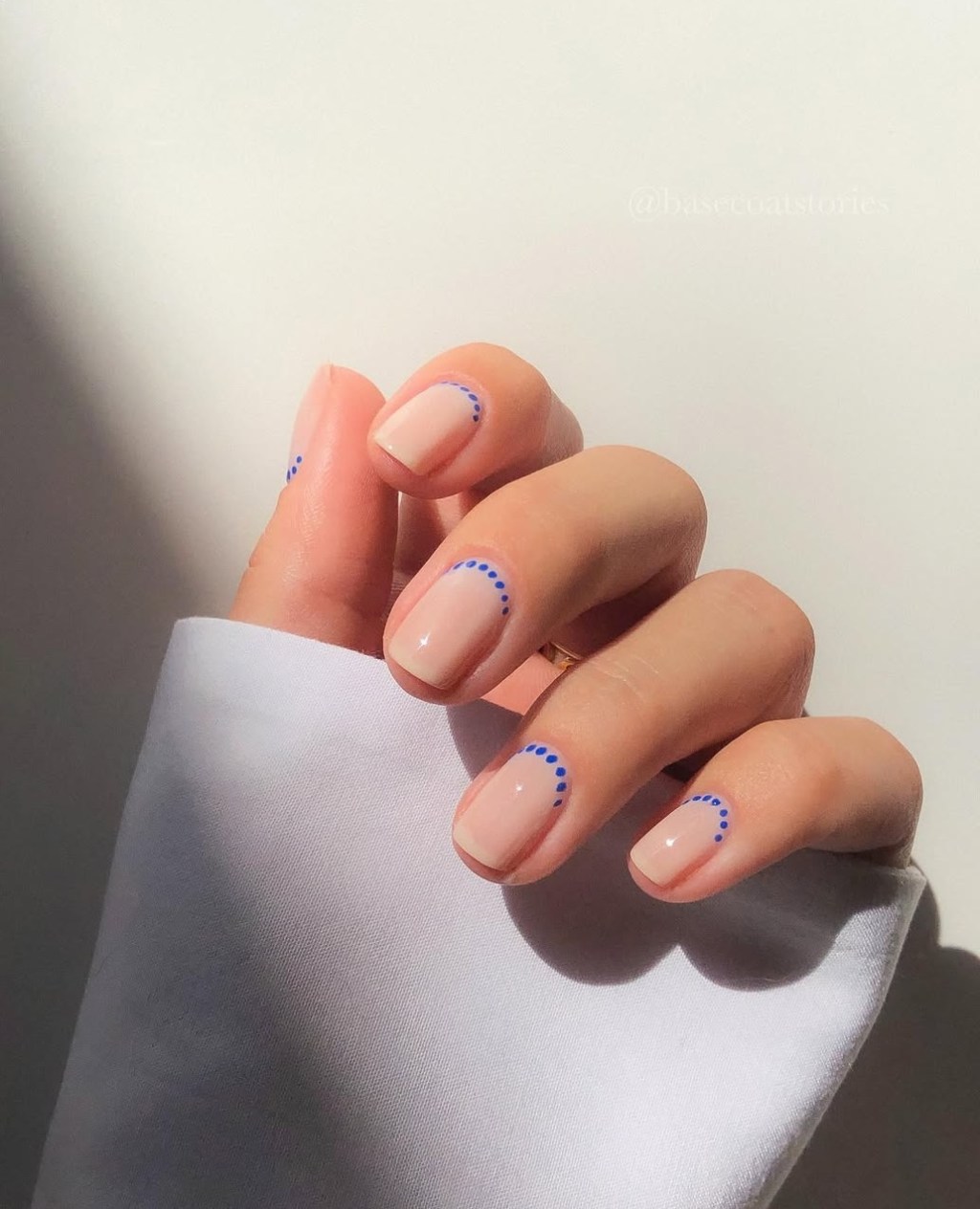 cute short beige simple nail ideas with easy blue dot designs at the base of each nail