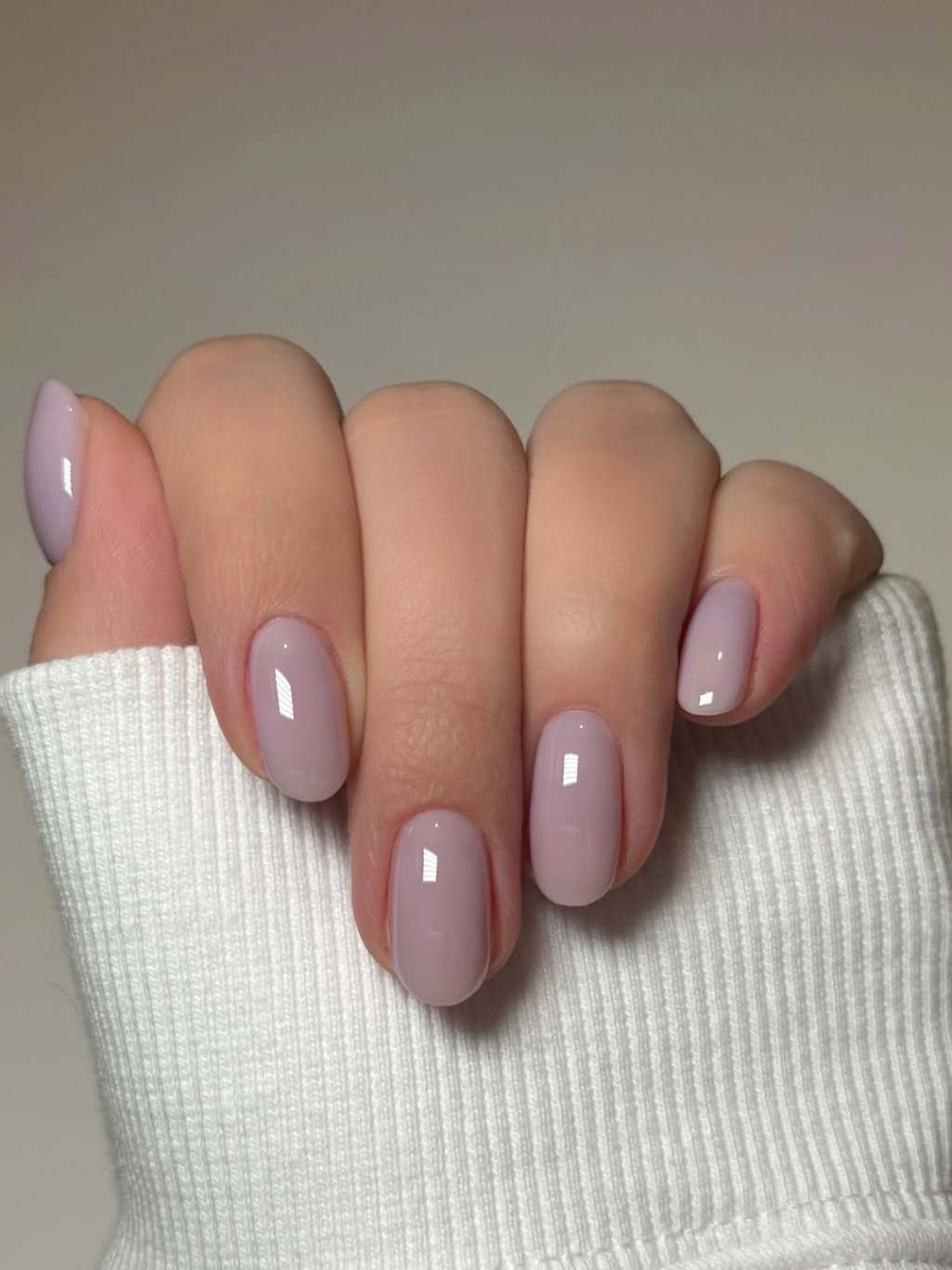 Milky lilac simple nail design on short rounded nails with a glossy finish