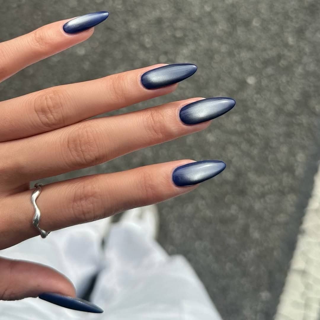 matte navy blue cat eye summer nails with a soft silver magnetic glow and ring.