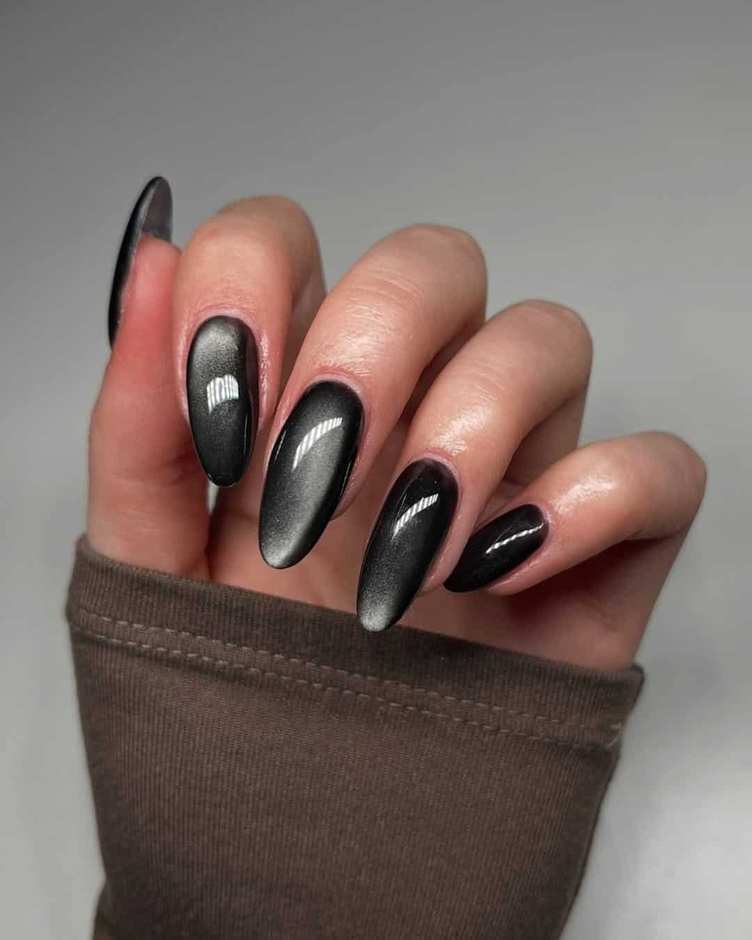 long almond shaped black cat eye summer nails with a velvety magnetic shimmer finish.