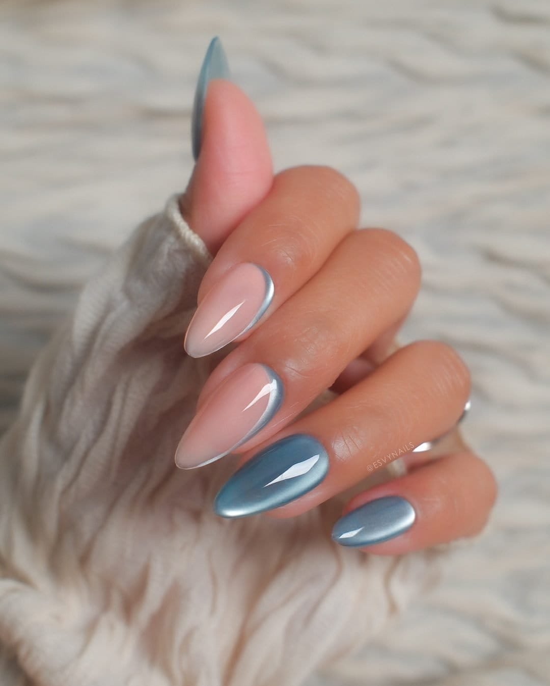 light blue cat eye summer nails with silver french tips and nude accent base.