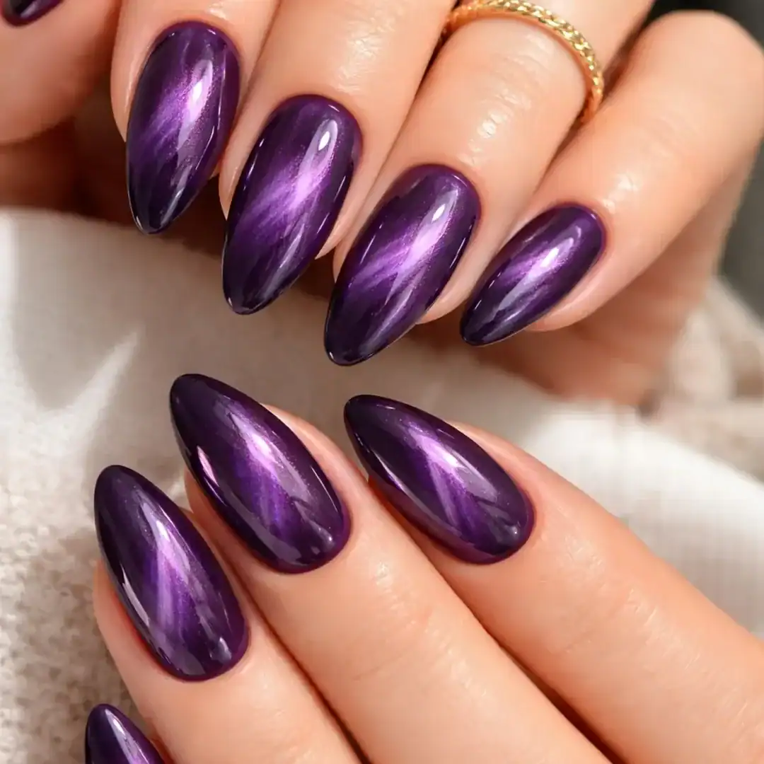 vibrant purple cat eye summer nails with deep violet tones and a bright magnetic streak.