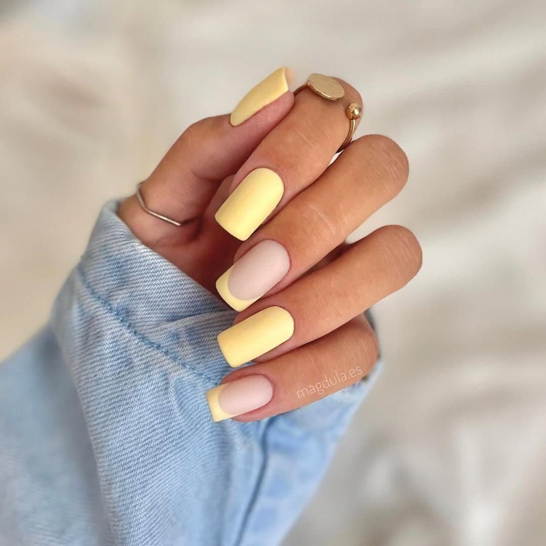 matte pale yellow manicure featuring alternating solid colors and minimalist french tips