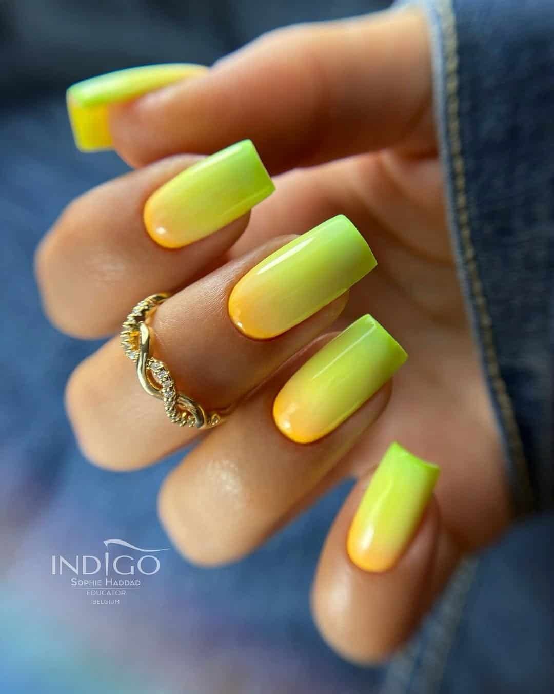 long square nails with a vibrant yellow and green ombré gradient manicure design